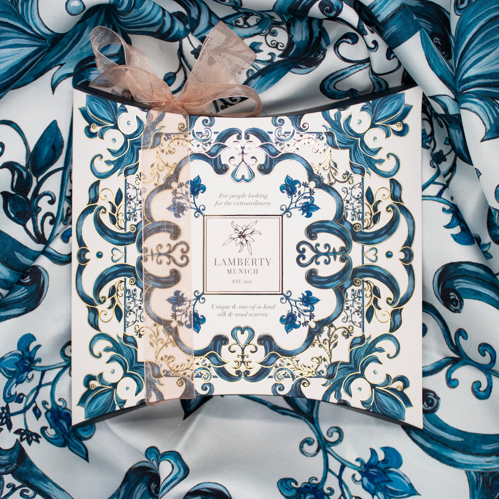 Example of Lamberty Munich gift packaging with an organza-ribbon gift box on the blue and white Majolica silk scarf